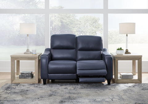Blue leather sofa in a living room setting with side tables and lamps.
