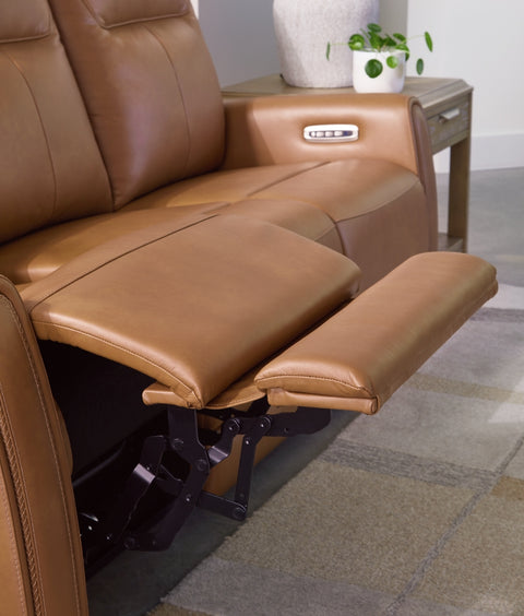 Brown leather recliner with footrest in a room setting