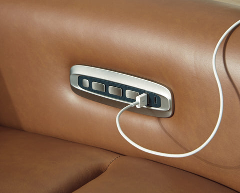 USB charging port on a brown leather car interior